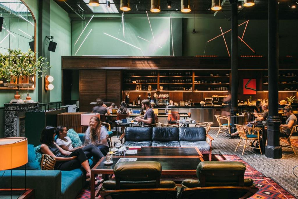 Hotel lounge with teal sofas, dark wood and a bar