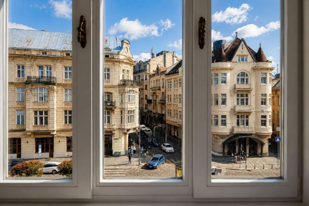 View through a hotel window onto a sunlit city street